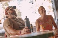 Stoney and Rebecca laughing at a table