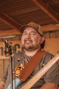 Mark with his bass at a microphone