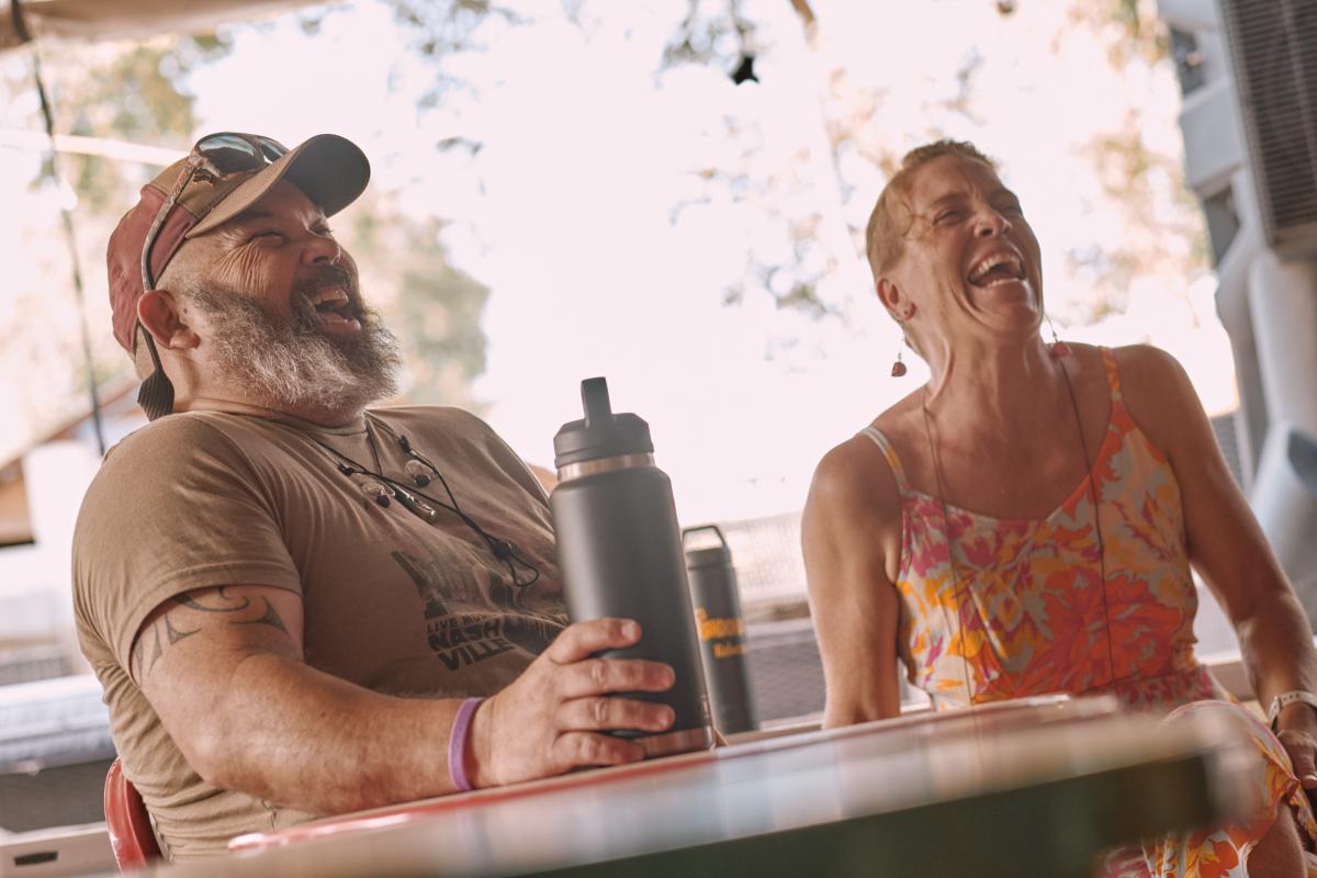 Stoney and Rebecca laughing at a table
