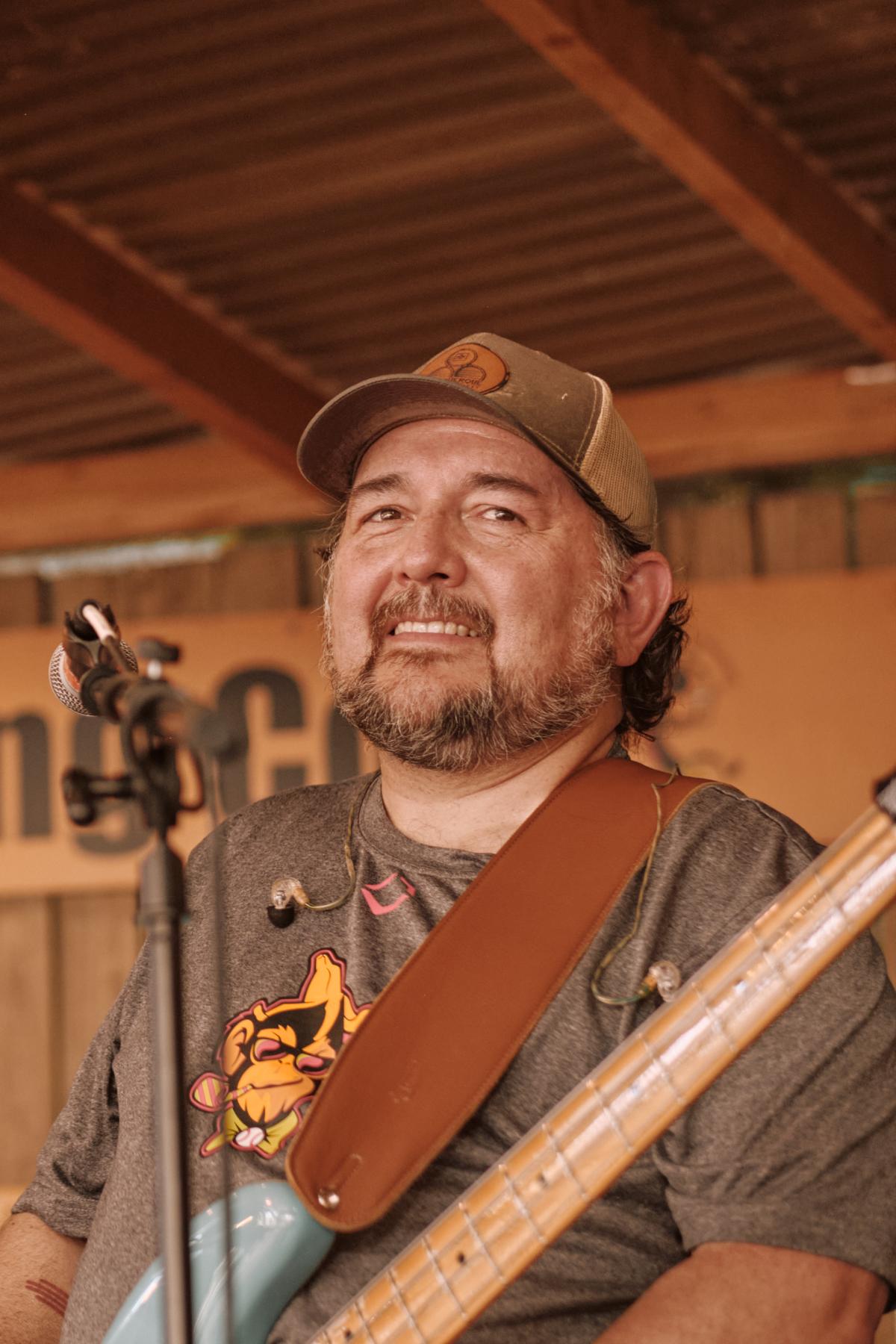 Mark with his bass at a microphone